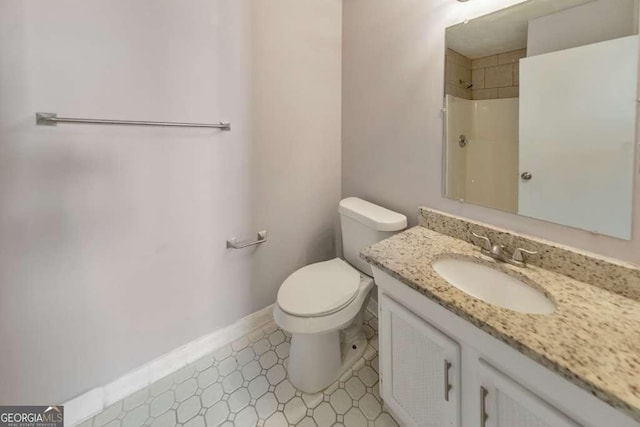 full bath featuring baseboards, walk in shower, toilet, and vanity