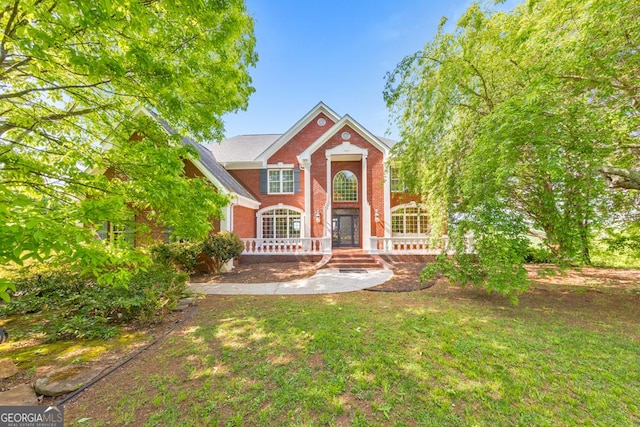 988 Hunters Rdg, Jasper, GA 30143 - traditional home featuring covered porch, brick siding, and a front lawn