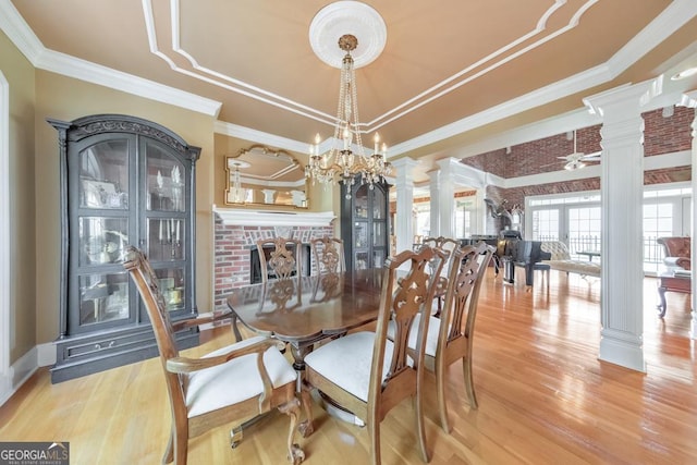 988 Hunters Rdg, Jasper, GA 30143 - dining area with crown molding, decorative columns, wood finished floors, a fireplace, and a raised ceiling