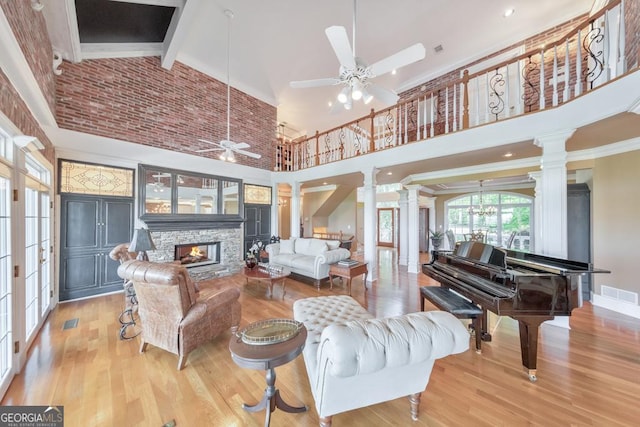 988 Hunters Rdg, Jasper, GA 30143 - living room featuring high vaulted ceiling, a stone fireplace, a ceiling fan, ornate columns, and visible vents
