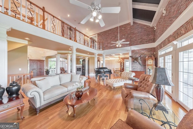 988 Hunters Rdg, Jasper, GA 30143 - living area featuring ornate columns, high vaulted ceiling, a ceiling fan, and wood finished floors