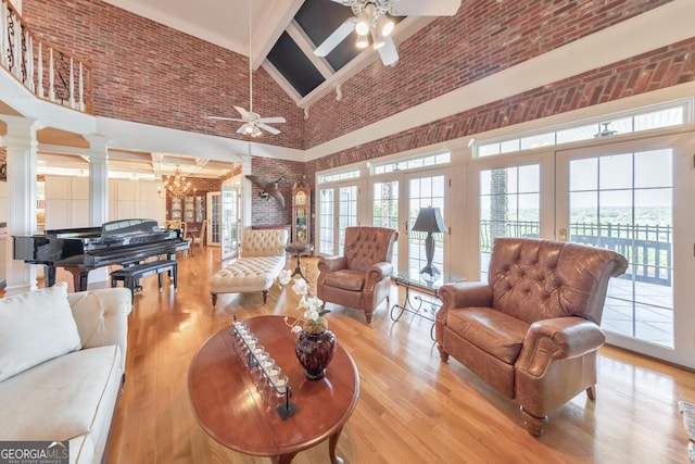 988 Hunters Rdg, Jasper, GA 30143 - living room with ornate columns, high vaulted ceiling, french doors, and ceiling fan with notable chandelier