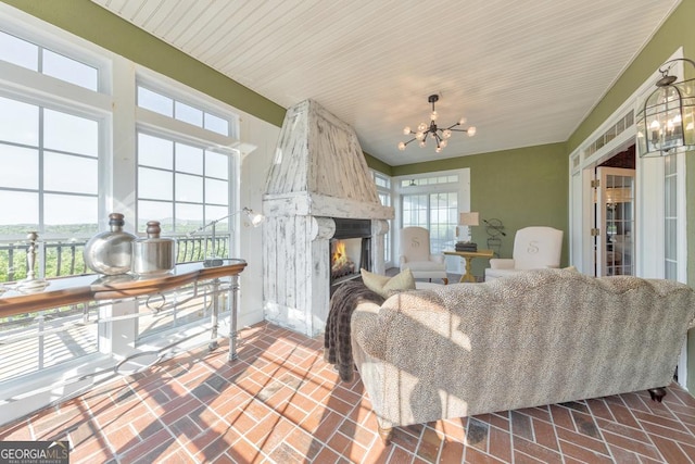 988 Hunters Rdg, Jasper, GA 30143 - living room featuring an inviting chandelier, baseboards, brick floor, and a premium fireplace