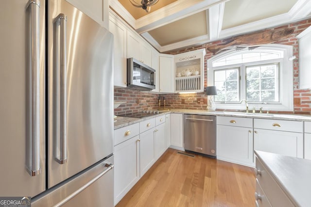 988 Hunters Rdg, Jasper, GA 30143 - kitchen with white cabinetry, a sink, light wood-style flooring, appliances with stainless steel finishes, and backsplash