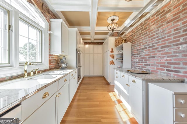 988 Hunters Rdg, Jasper, GA 30143 - kitchen featuring a sink, beam ceiling, light wood-style floors, white cabinetry, and coffered ceiling