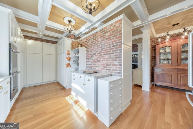 988 Hunters Rdg, Jasper, GA 30143 - kitchen with light wood-style floors, coffered ceiling, double oven, and an inviting chandelier
