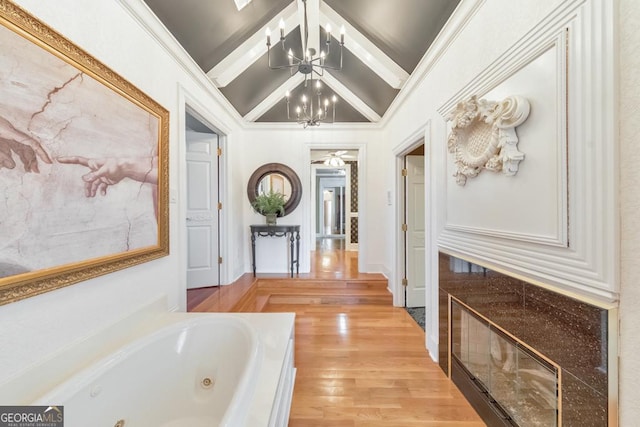988 Hunters Rdg, Jasper, GA 30143 - hall with lofted ceiling with beams, light wood-style flooring, and a chandelier
