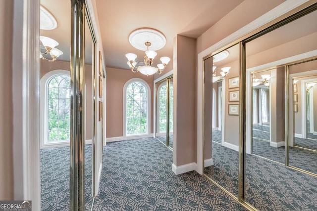 988 Hunters Rdg, Jasper, GA 30143 - foyer with baseboards, dark colored carpet, and a chandelier