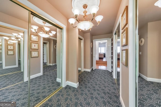 988 Hunters Rdg, Jasper, GA 30143 - hall featuring baseboards, a chandelier, and dark carpet