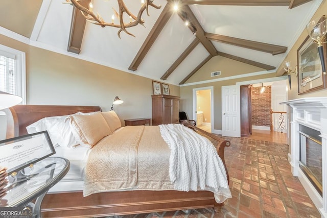 988 Hunters Rdg, Jasper, GA 30143 - bedroom with brick floor, visible vents, a notable chandelier, a glass covered fireplace, and vaulted ceiling with beams