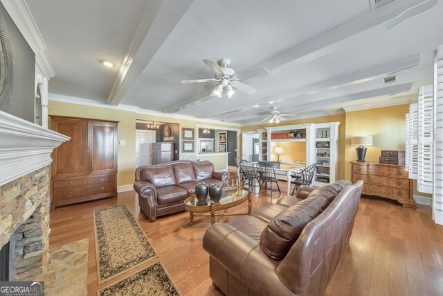988 Hunters Rdg, Jasper, GA 30143 - living area with beam ceiling, a stone fireplace, light wood-type flooring, visible vents, and ornamental molding