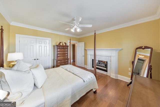 988 Hunters Rdg, Jasper, GA 30143 - bedroom featuring ornamental molding, a ceiling fan, a high end fireplace, dark wood-style floors, and a closet