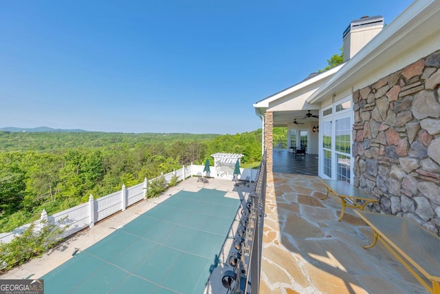 988 Hunters Rdg, Jasper, GA 30143 - view of patio / terrace with fence, a view of trees, and a ceiling fan