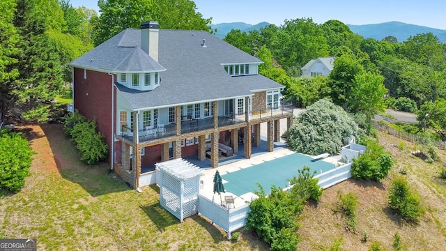 988 Hunters Rdg, Jasper, GA 30143 - rear view of property with a mountain view, roof with shingles, a patio area, and a chimney