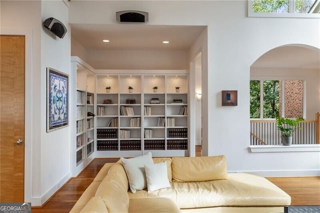 4835 Merlendale Ct, Atlanta, GA 30327 - living area featuring arched walkways, wood finished floors, and baseboards
