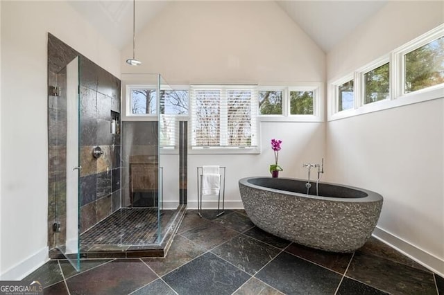 4835 Merlendale Ct, Atlanta, GA 30327 - full bathroom with vaulted ceiling, a shower stall, a freestanding tub, and baseboards