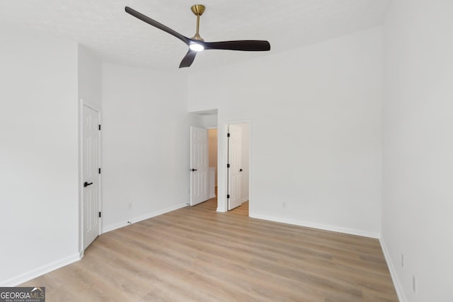unfurnished dining area featuring light wood finished floors, a wainscoted wall, visible vents, an inviting chandelier, and a decorative wall