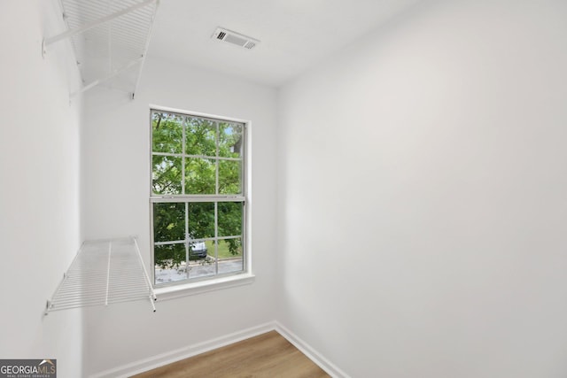 spare room with light wood-style flooring, a ceiling fan, and baseboards