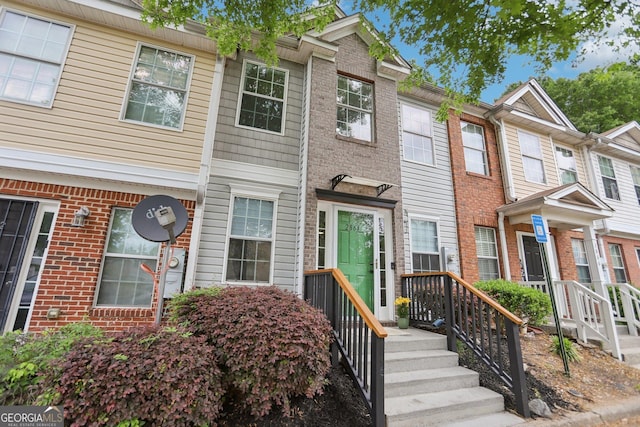 townhome / multi-family property featuring brick siding