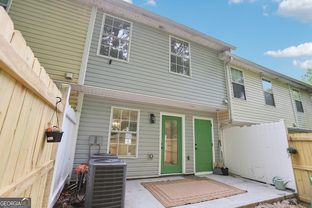 rear view of house featuring cooling unit, a patio, and fence