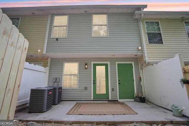 back of house featuring fence and cooling unit