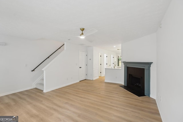 entryway with ceiling fan, baseboards, a healthy amount of sunlight, and wood finished floors