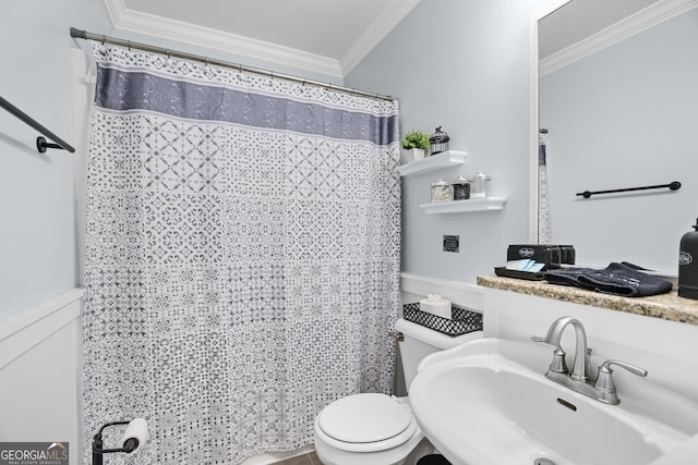 bathroom with a shower with shower curtain, toilet, ornamental molding, and a sink