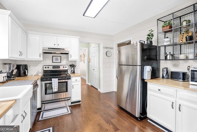 kitchen with stainless steel appliances, dark wood-style floors, white cabinetry, and under cabinet range hood