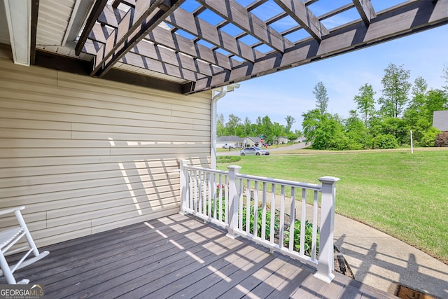 wooden terrace featuring a lawn, a pergola, and covered porch
