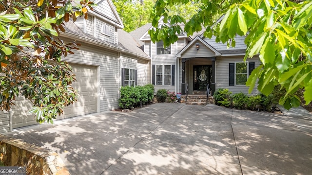 view of front of property with driveway and a shingled roof