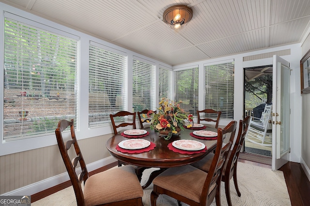 dining room with baseboards, light wood-style flooring, and a healthy amount of sunlight