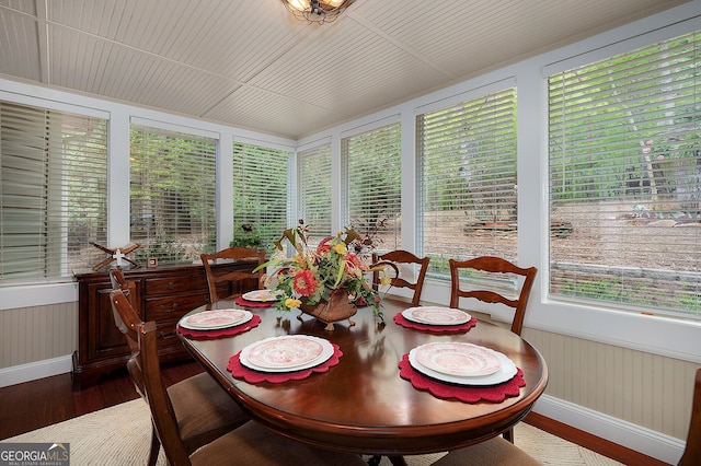 sunroom with wood finished floors and baseboards