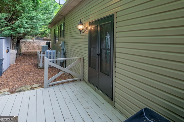 wooden terrace featuring fence and central air condition unit