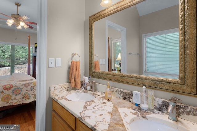 full bathroom featuring wood finished floors, ceiling fan, connected bathroom, and a sink