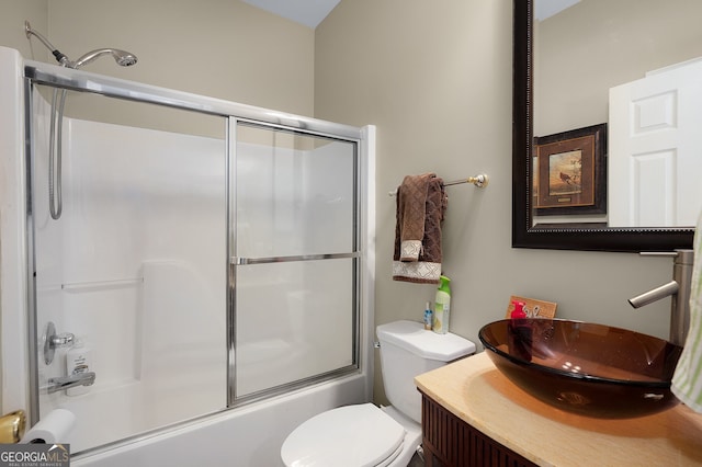 bathroom with shower / bath combination with glass door, toilet, and vanity