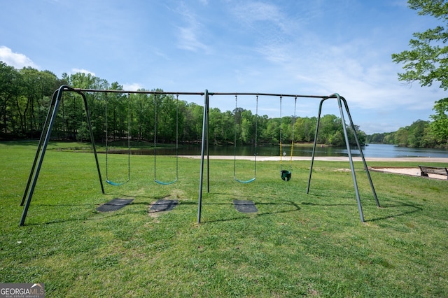 community playground featuring a water view and a lawn