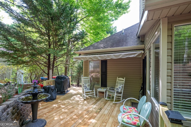 wooden terrace featuring area for grilling