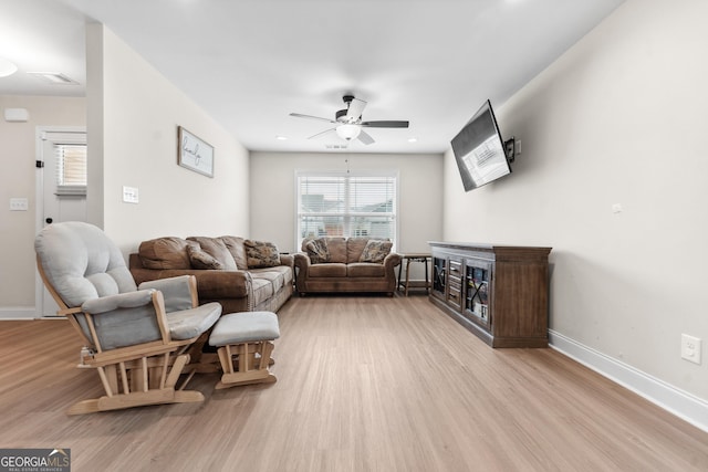 living area with baseboards, a ceiling fan, light wood-style floors, and recessed lighting