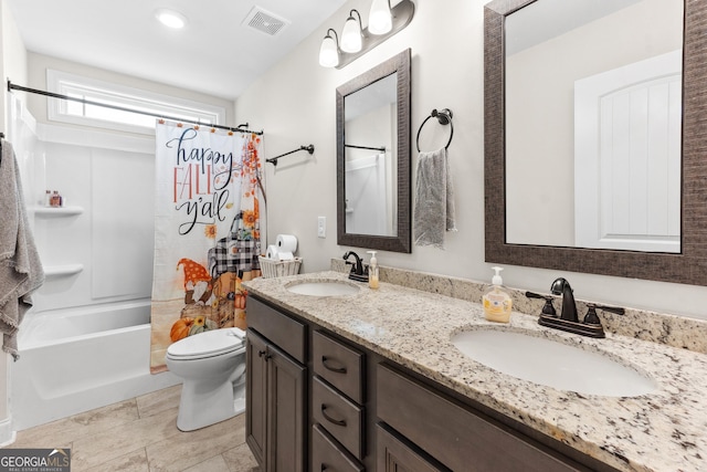 full bathroom with visible vents, a sink, double vanity, and toilet