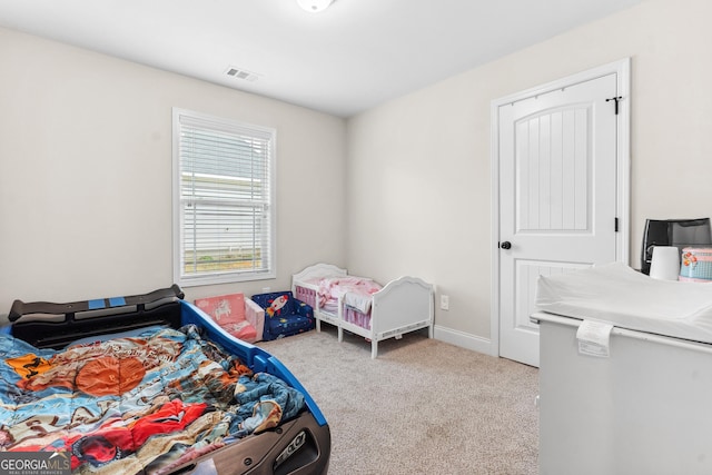 carpeted bedroom featuring visible vents