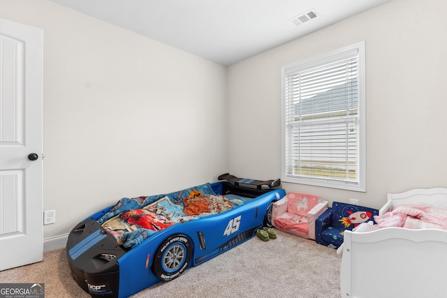 bedroom featuring carpet floors, multiple windows, and visible vents