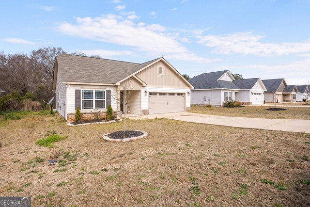 view of front of property with an attached garage, driveway, a shingled roof, and a front lawn