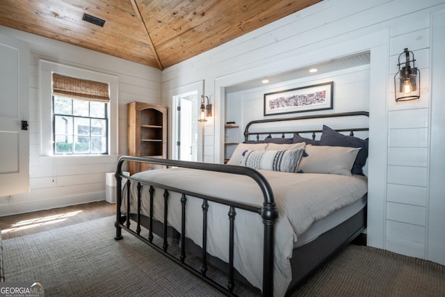 carpeted bedroom featuring wood walls, lofted ceiling, and wood ceiling