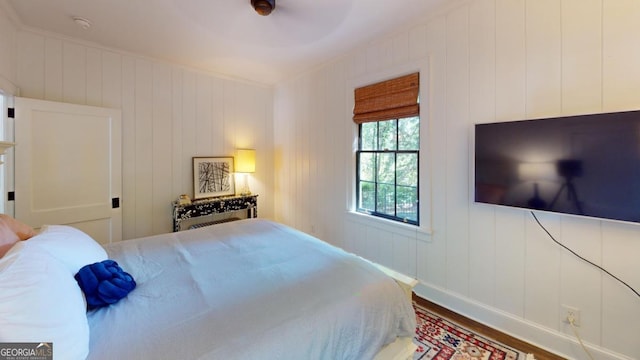 bedroom featuring baseboards and wood finished floors