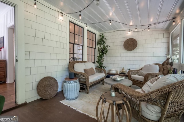 sunroom / solarium featuring track lighting