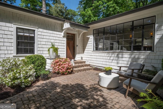 view of exterior entry with a patio