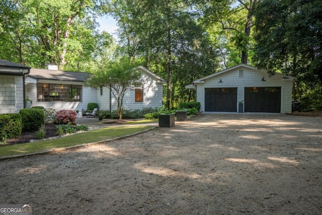 exterior space featuring a garage and an outdoor structure