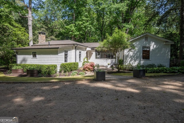 rear view of property with a chimney