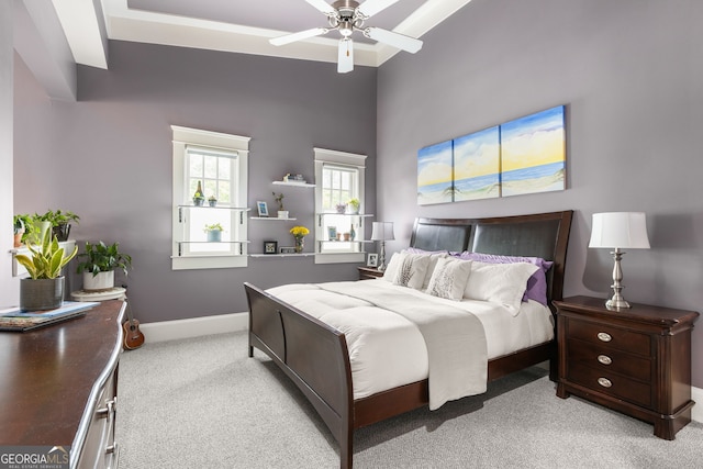 bedroom featuring baseboards, ceiling fan, and light colored carpet