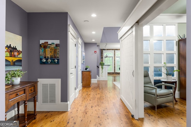 corridor featuring visible vents, recessed lighting, light wood finished floors, and baseboards